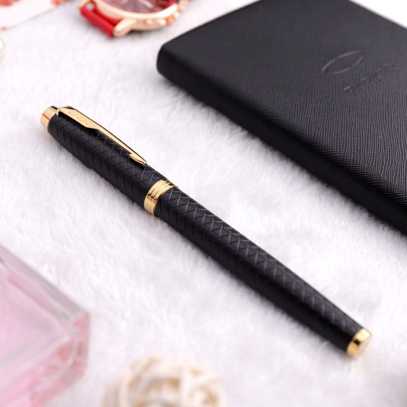 Parker IM Black Forest Fountain Pen beside notebook