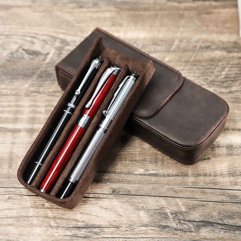 Open vintage leather pen case with 3 pens in pull-out tray