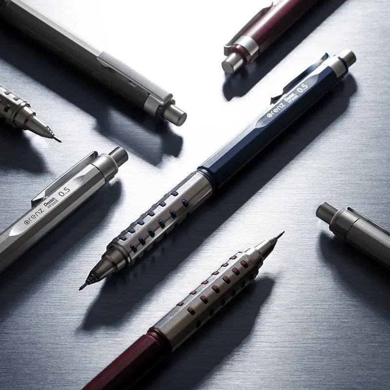 Pentel Orenz AT Dual Grip 0.5mm mechanical pencils displayed on metal desk