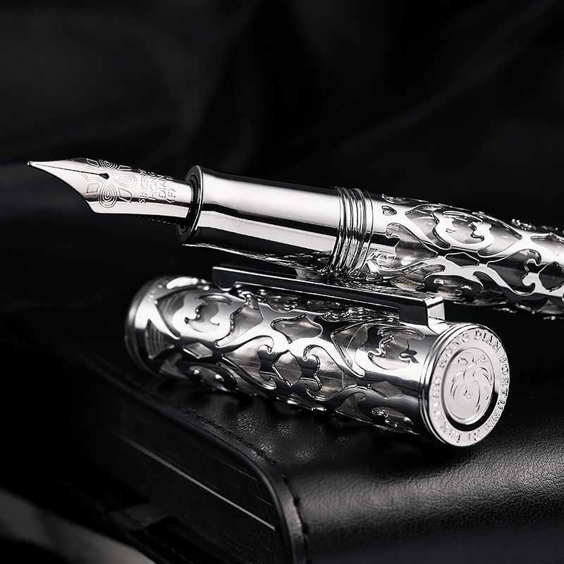 Hongdian ornate silver-tone fountain pen standing with cap beside it